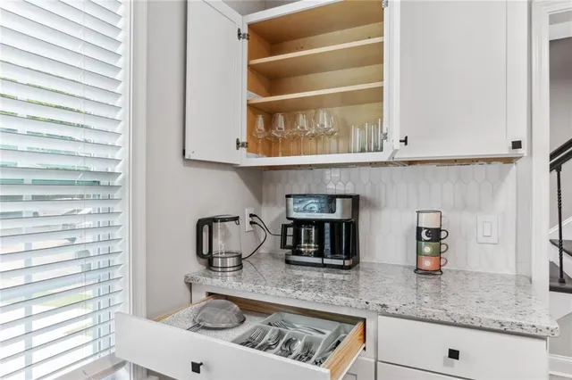 a kitchen with granite countertop a sink and a stove