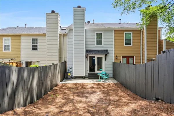 a front view of house with wooden fence