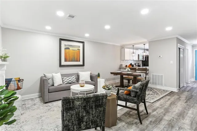 a living room with furniture and wooden floor