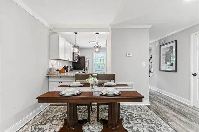 a kitchen with a table chairs and stove