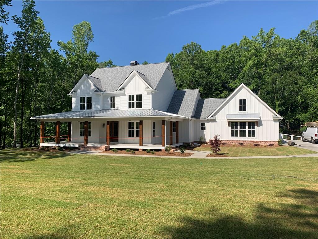 3511 Reavis Mountain Road, Unit 2 Ball Ground, GA 30107 - Photo 1 of 14 a front view of a house with garden