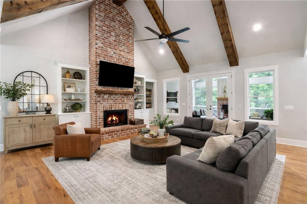 3511 Reavis Mountain Road, Unit 2 Ball Ground, GA 30107 - Photo 4 of 14 a living room with furniture a large window and a fireplace