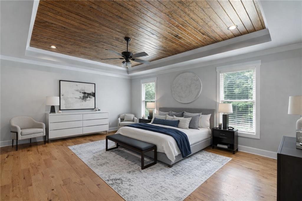 3511 Reavis Mountain Road, Unit 2 Ball Ground, GA 30107 - Photo 7 of 14 a spacious bedroom with a bed a chandelier and dresser