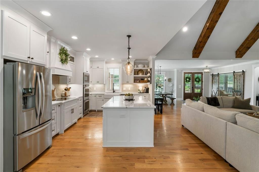 3511 Reavis Mountain Road, Unit 2 Ball Ground, GA 30107 - Photo 8 of 14 a large kitchen with stainless steel appliances kitchen island a large counter top and a refrigerator