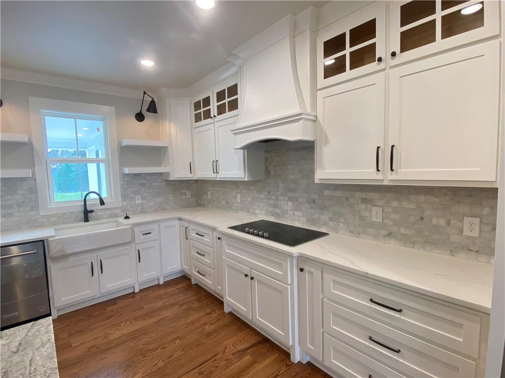 3511 Reavis Mountain Road, Unit 2 Ball Ground, GA 30107 - Photo 9 of 14 a kitchen with stainless steel appliances granite countertop a sink and cabinets with wooden floor