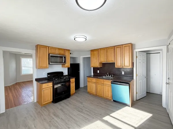 a kitchen with stainless steel appliances granite countertop a stove top oven and sink