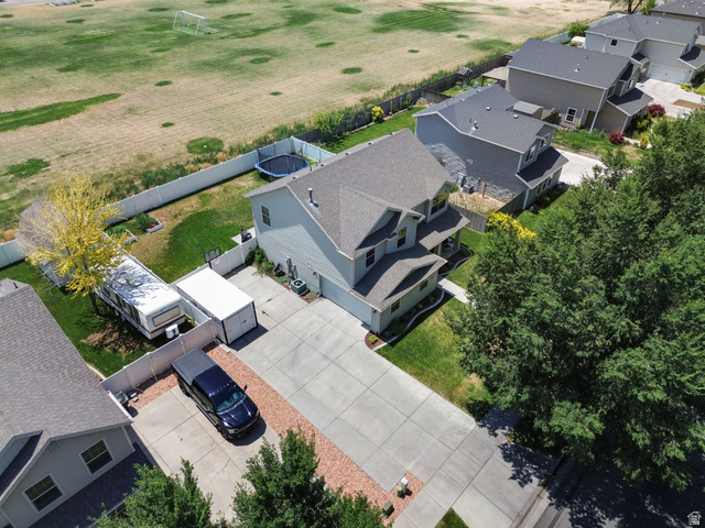 1393 West 150 North Springville, UT 84663 - Photo 24 of 31 Two-story residence featuring a paved driveway, mature trees, and a fully fenced backyard