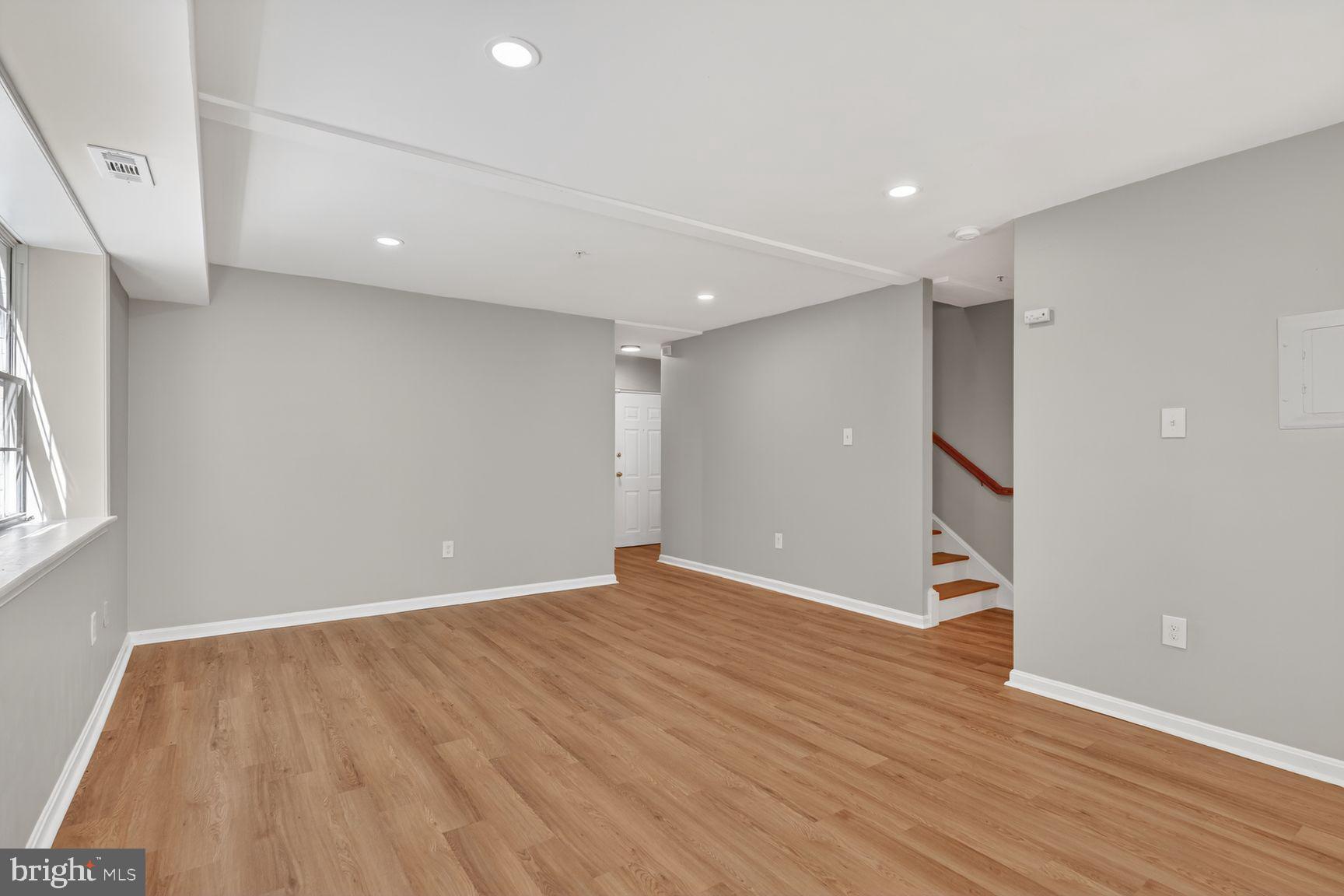 1008 Rittenhouse Street Northwest, Unit 15 Washington, DC 20011 - Photo 4 of 39 wooden floor in an empty room with a window