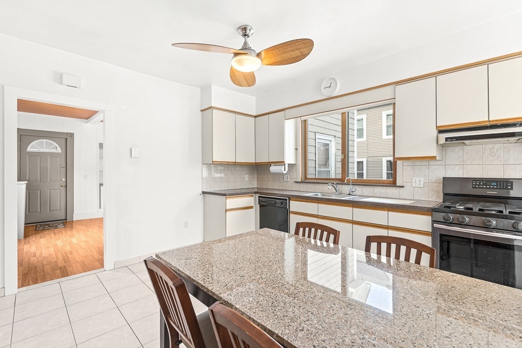 20 Pond Street Stoneham, MA 02180 - Photo 11 of 35 a kitchen with stainless steel appliances granite countertop a stove a sink and a microwave