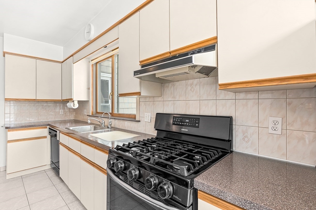 20 Pond Street Stoneham, MA 02180 - Photo 12 of 35 a kitchen with white cabinets and appliances