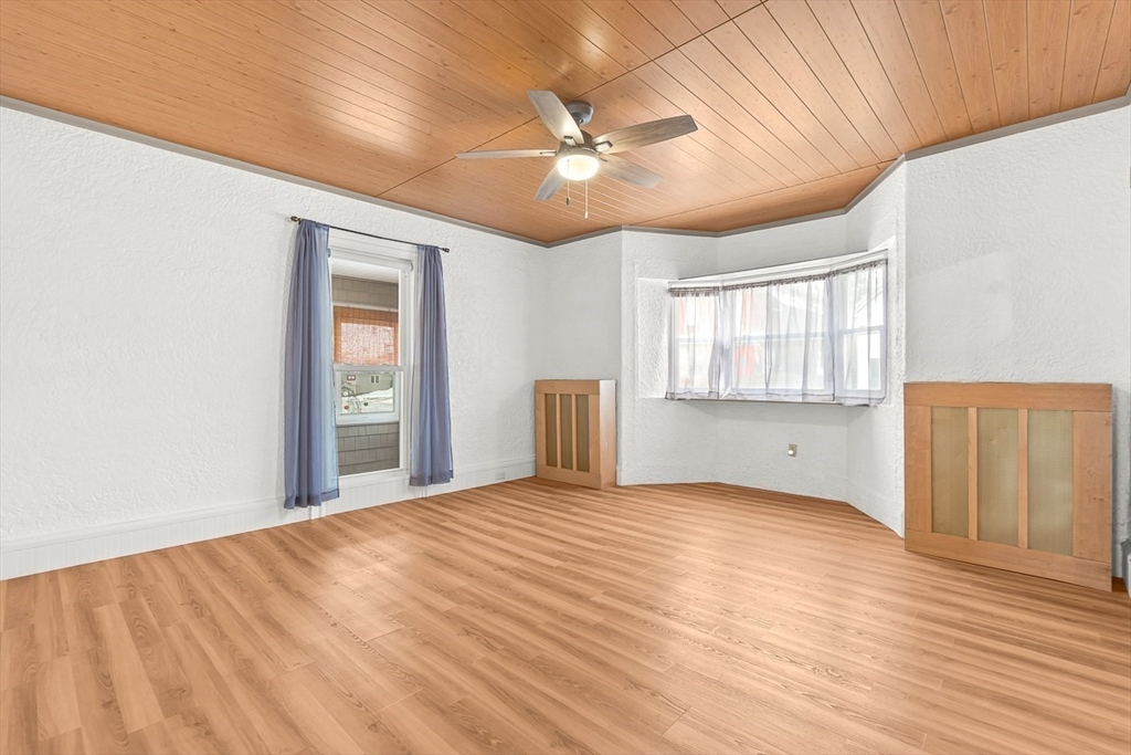 20 Pond Street Stoneham, MA 02180 - Photo 16 of 35 a view of an empty room with window and wooden floor