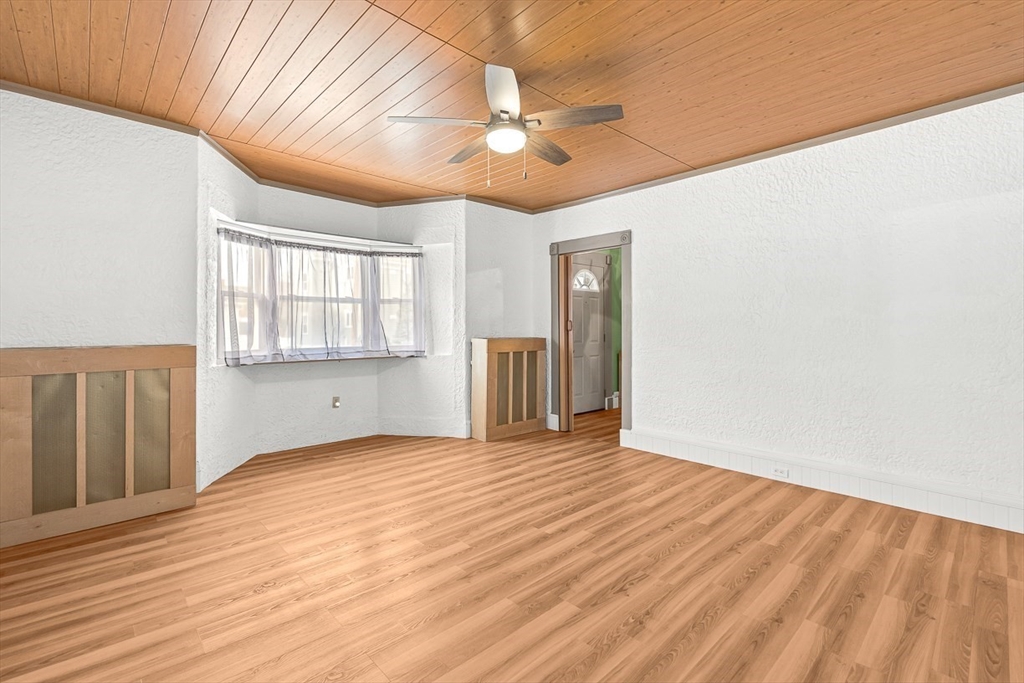 20 Pond Street Stoneham, MA 02180 - Photo 17 of 35 a view of an empty room with wooden floor and a window