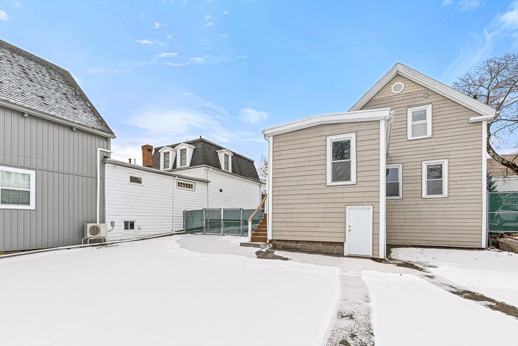 20 Pond Street Stoneham, MA 02180 - Photo 29 of 35 a view of a house with a wooden fence