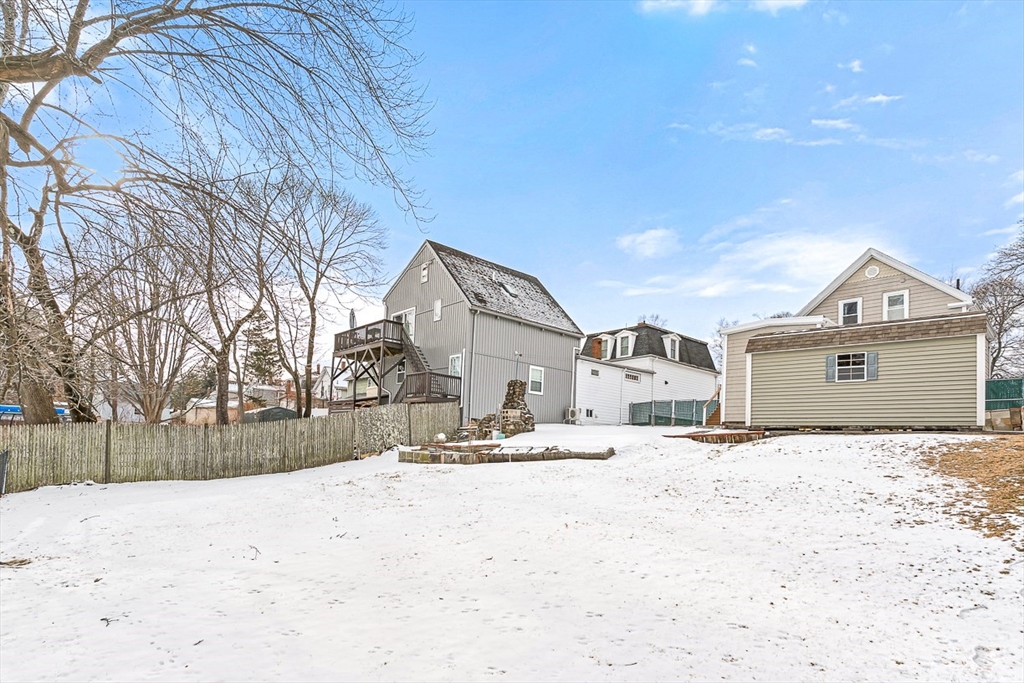 20 Pond Street Stoneham, MA 02180 - Photo 33 of 35 a front view of a house with a yard covered in snow