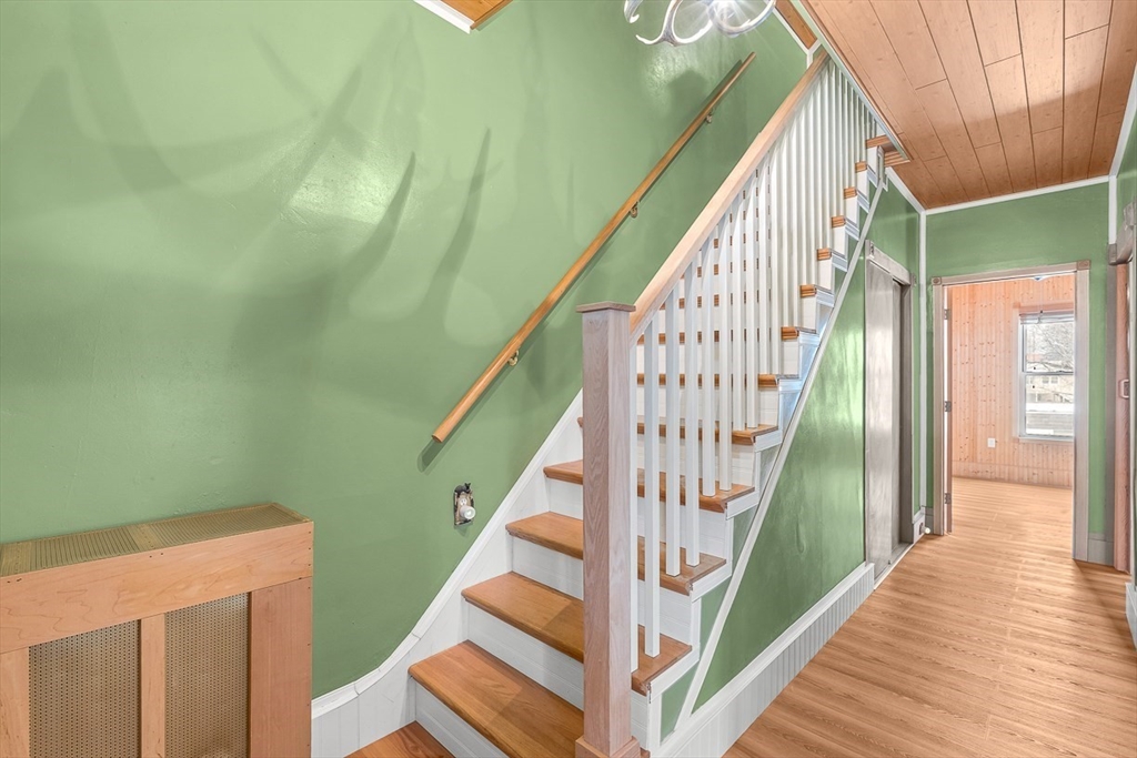 20 Pond Street Stoneham, MA 02180 - Photo 7 of 35 a view of staircase with wooden floor and white walls