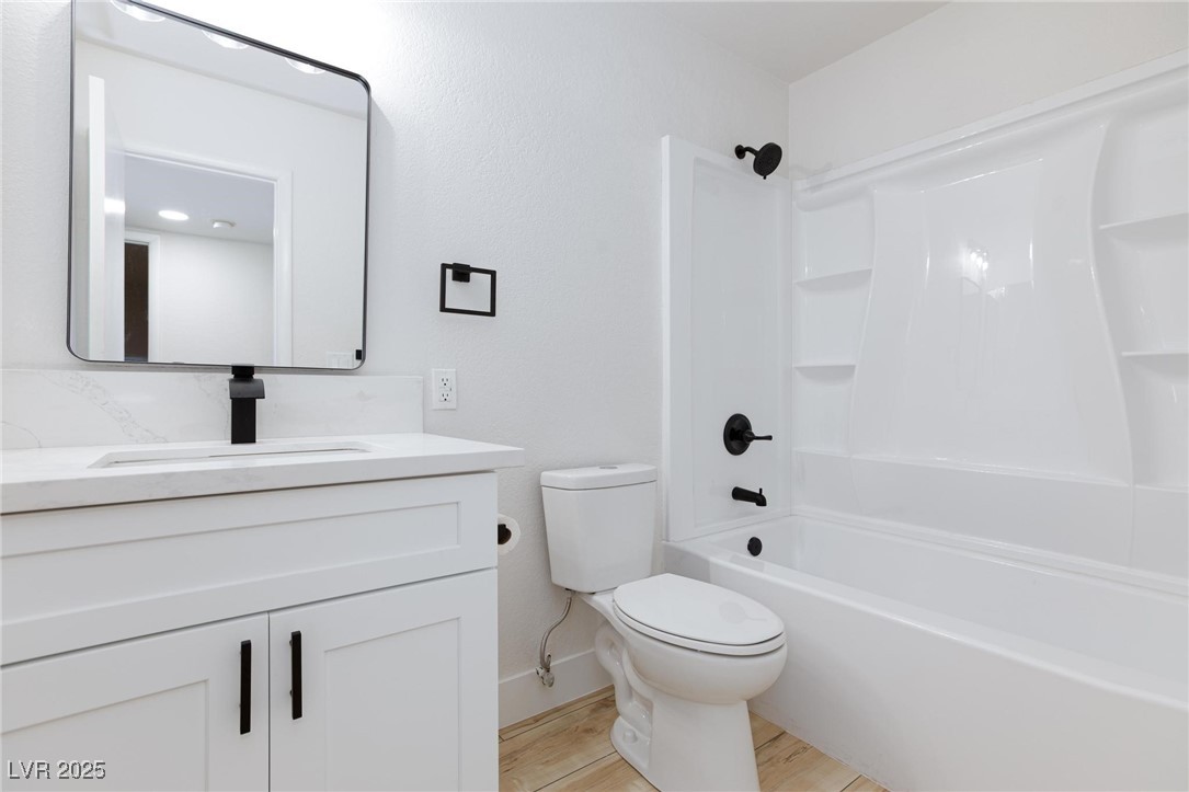 5905 Smoke Ranch Road, Unit A Las Vegas, NV 89108 - Photo 17 of 31 Full bath with shower / bathtub combination, vanity, and light wood finished floors
