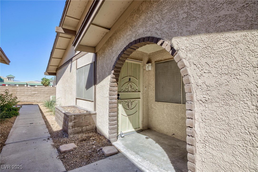 5905 Smoke Ranch Road, Unit A Las Vegas, NV 89108 - Photo 29 of 31 View of exterior entry with stucco siding