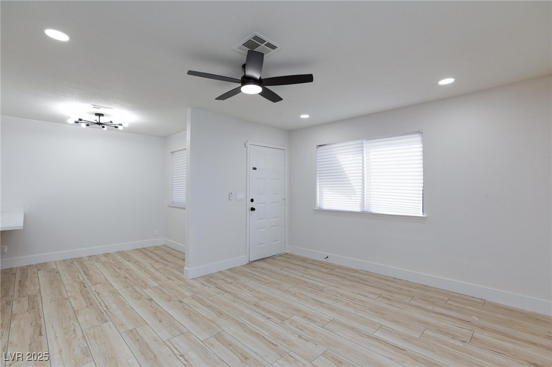 5905 Smoke Ranch Road, Unit A Las Vegas, NV 89108 - Photo 7 of 31 Unfurnished room with light wood finished floors, plenty of natural light, recessed lighting, and a ceiling fan