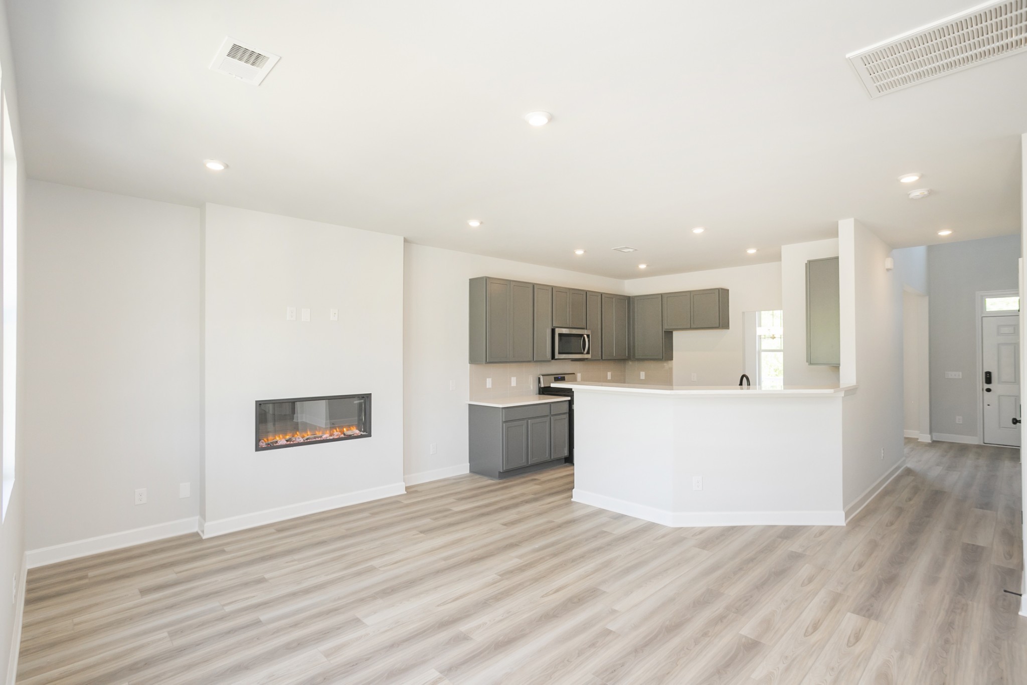 128 Millbrook Dr Spring Hill Spring Hill, TN 37174 - Photo 11 of 19 a view of kitchen with kitchen island a refrigerator wooden floor and a stove top oven