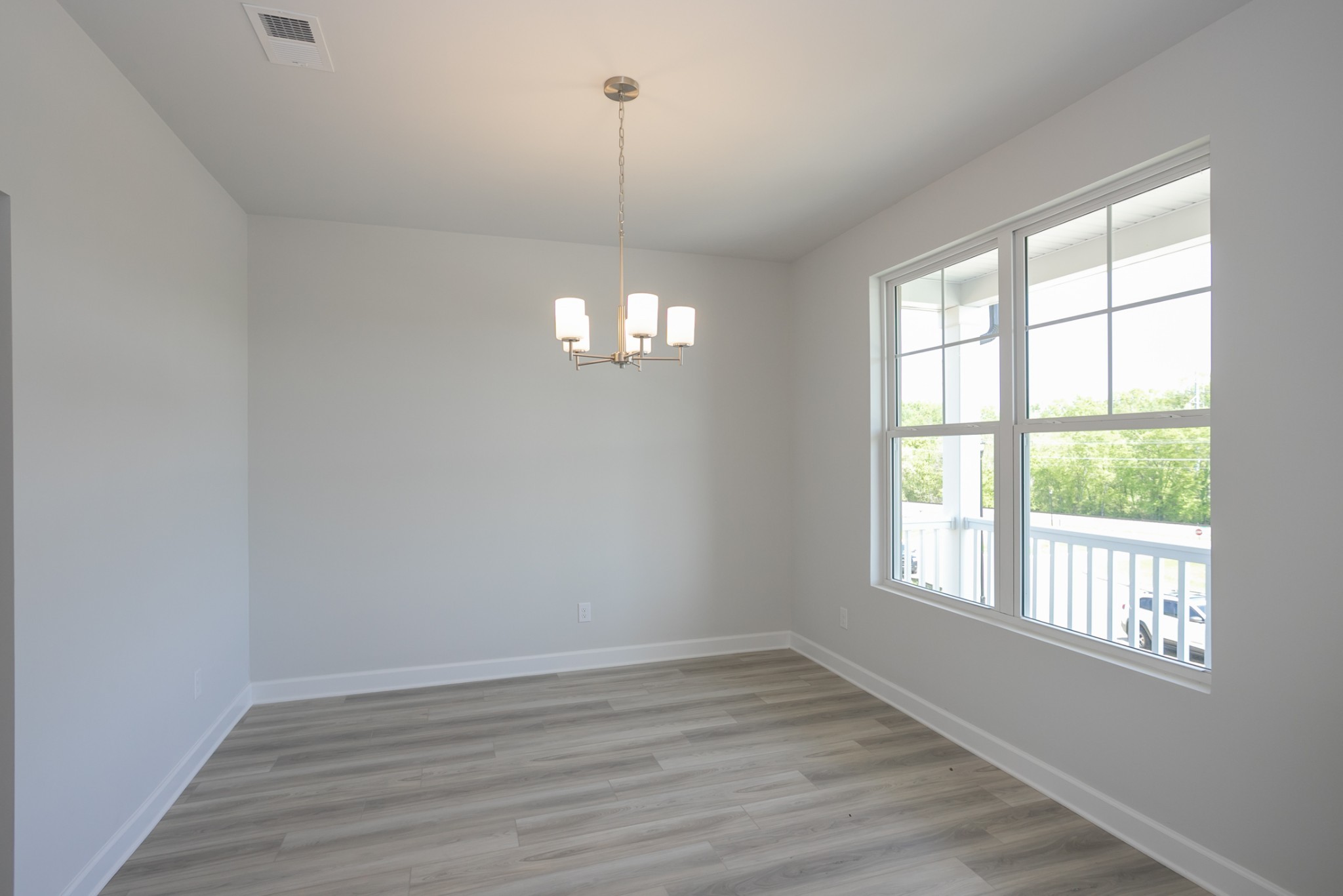 128 Millbrook Dr Spring Hill Spring Hill, TN 37174 - Photo 9 of 19 a view of an empty room with wooden floor and a window