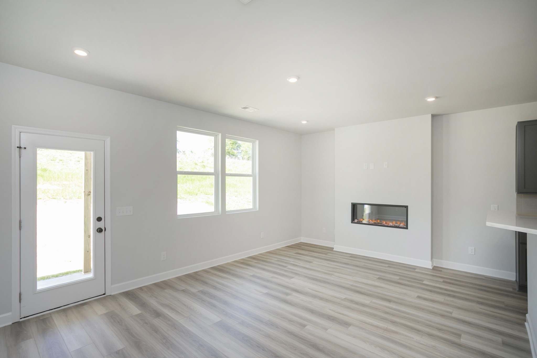 128 Millbrook Dr Spring Hill Spring Hill, TN 37174 - Photo 10 of 19 an empty room with wooden floor and windows