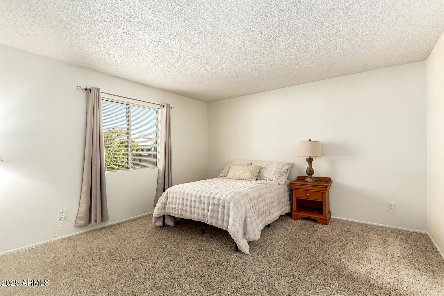 1312 East Stephens Drive Tempe, AZ 85283 - Photo 11 of 26 a bedroom with a bed and a window