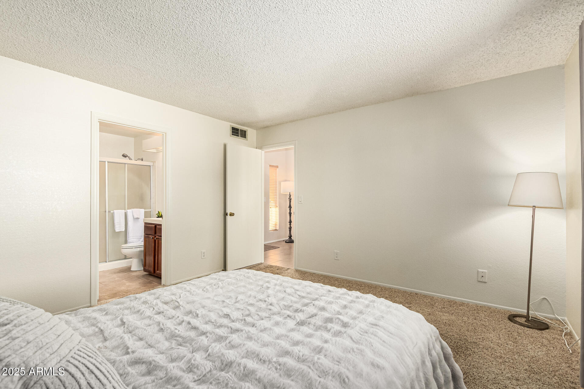 1312 East Stephens Drive Tempe, AZ 85283 - Photo 12 of 26 a bedroom with a bed and a mirror
