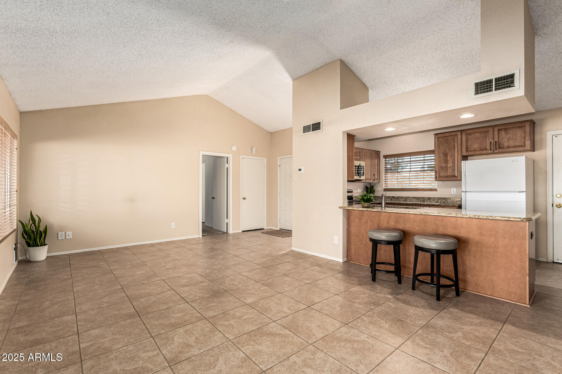 1312 East Stephens Drive Tempe, AZ 85283 - Photo 7 of 26 a view of kitchen with furniture and refrigerator