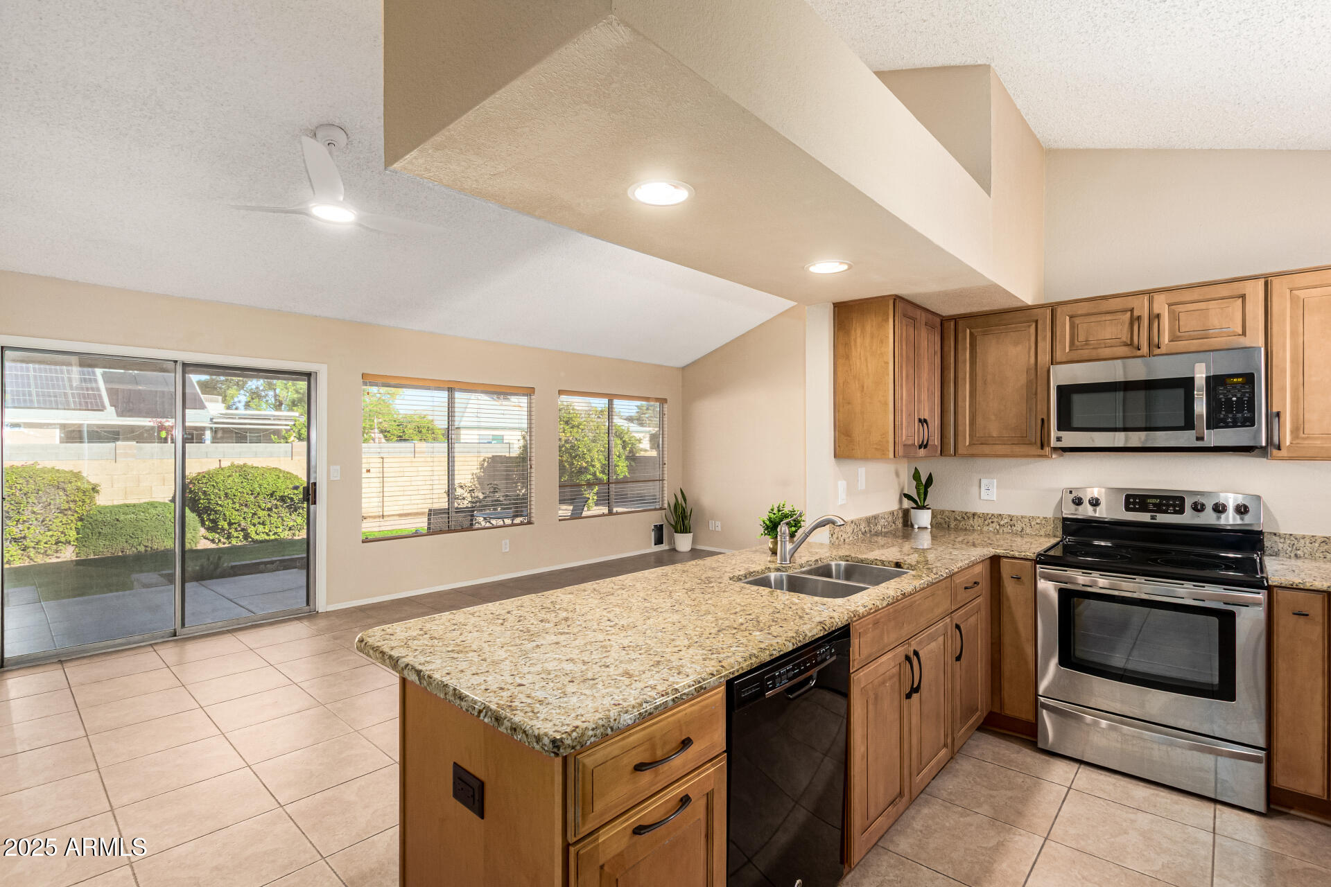 1312 East Stephens Drive Tempe, AZ 85283 - Photo 10 of 26 a kitchen with stainless steel appliances granite countertop a stove a sink and a microwave