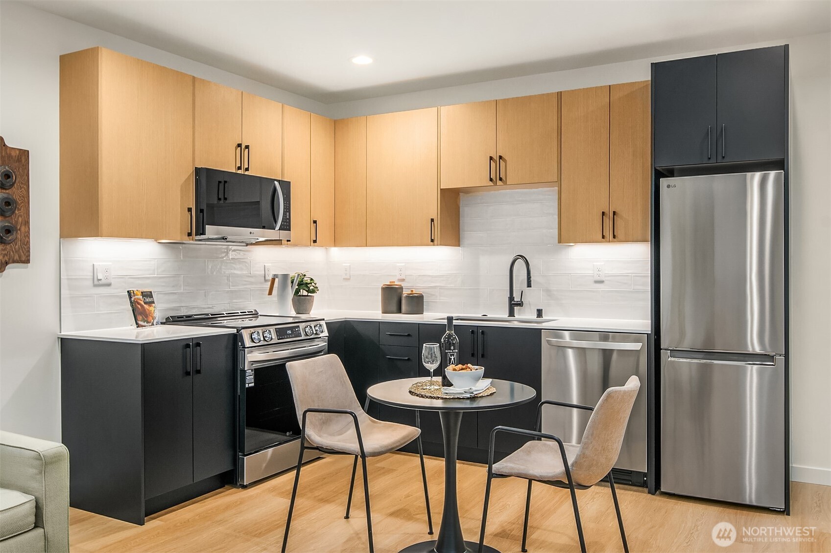 1457 22nd Avenue, Unit A Seattle, WA 98122 - Photo 3 of 15 a kitchen with stainless steel appliances a stove a sink a refrigerator a dining table and chairs