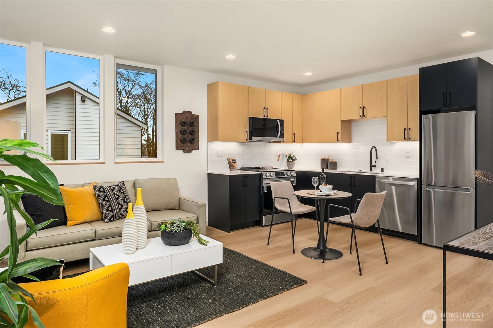 1457 22nd Avenue, Unit A Seattle, WA 98122 - Photo 6 of 15 a living room with stainless steel appliances kitchen island granite countertop furniture and a rug
