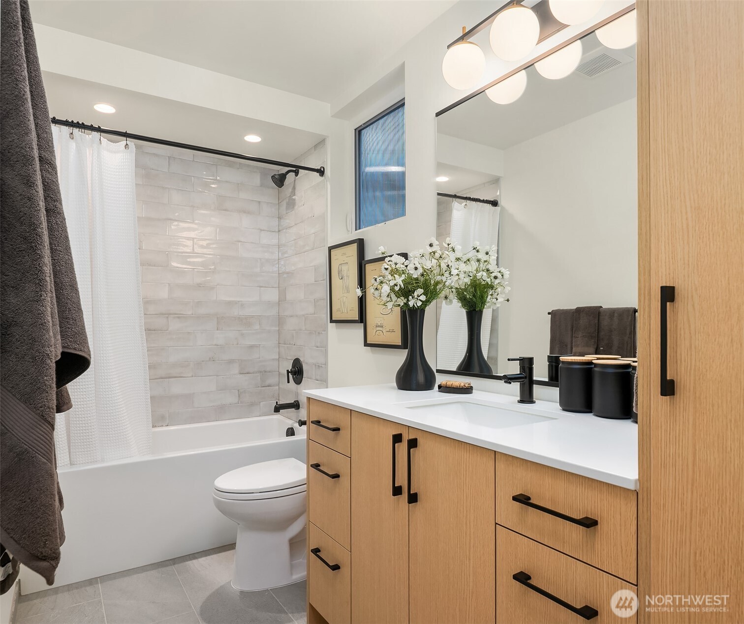 1457 22nd Avenue, Unit A Seattle, WA 98122 - Photo 10 of 15 a bathroom with a granite countertop sink a toilet and shower