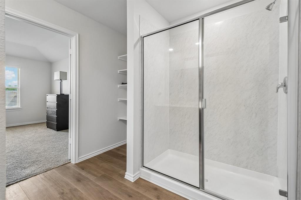 1453 Millstead Rill Road Caddo Mills, TX 75135 - Photo 33 of 40 Walk-in shower with a glass enclosure and textured white surround