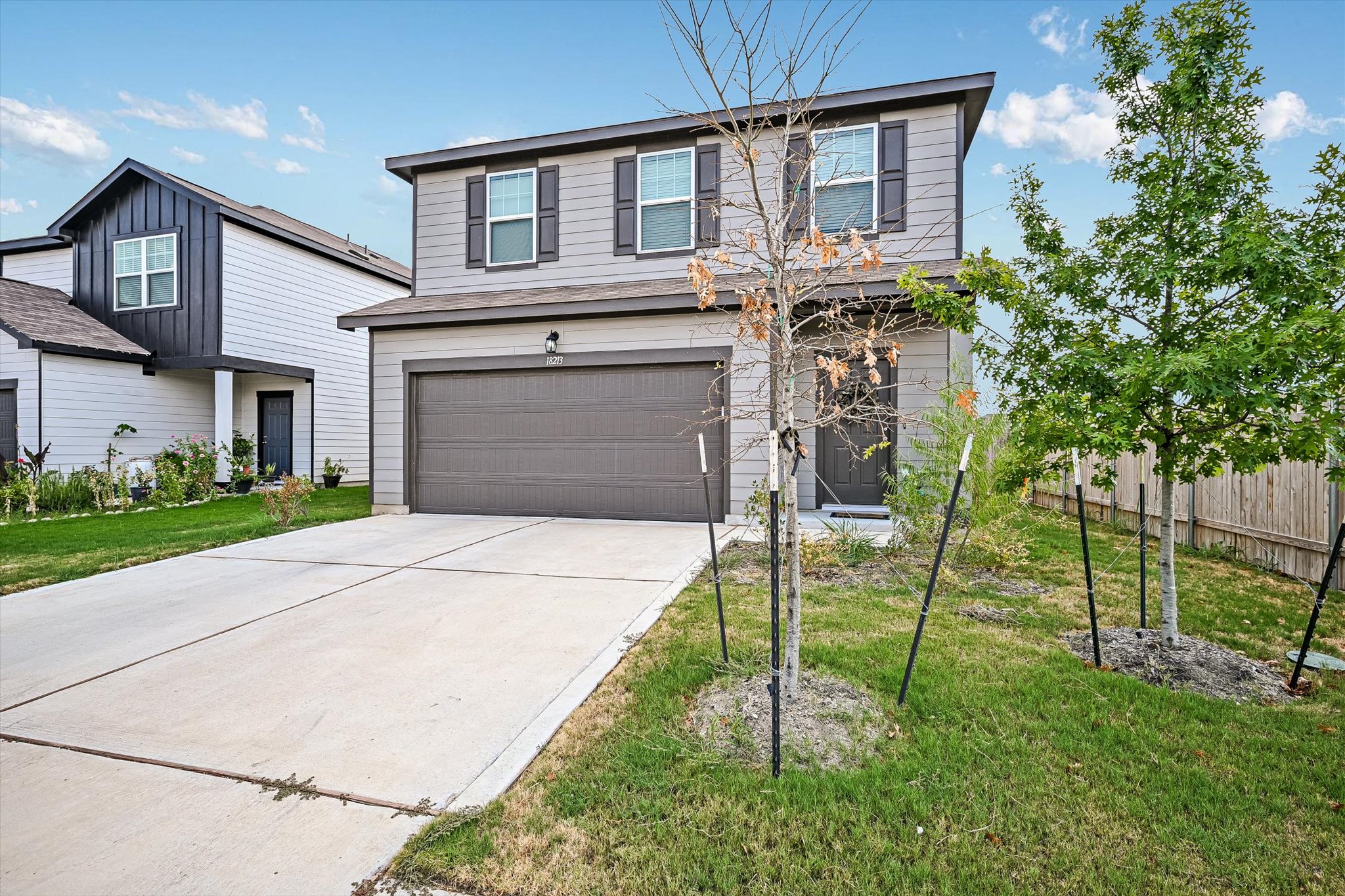 18213 Stellers Sea Street Elgin, TX 78621 - Photo 1 of 20 A contemporary two-story exterior showcases horizontal siding, decorative shutters, and a concrete driveway.