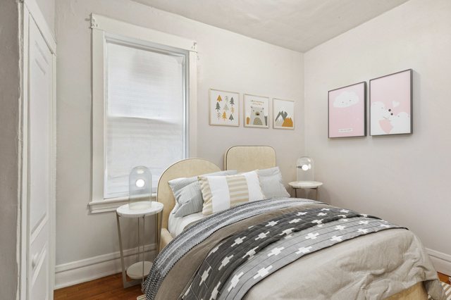 1912 South Harding Avenue Chicago, IL 60623 - Photo 11 of 16 a bedroom with a bed and wooden floor