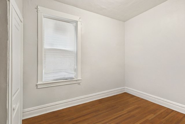 1912 South Harding Avenue Chicago, IL 60623 - Photo 12 of 16 a view of a small space with wooden floor and a window