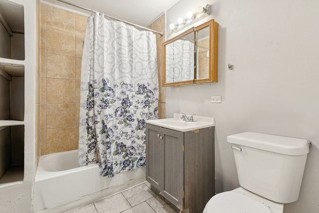1912 South Harding Avenue Chicago, IL 60623 - Photo 13 of 16 a bathroom with a sink toilet and shower