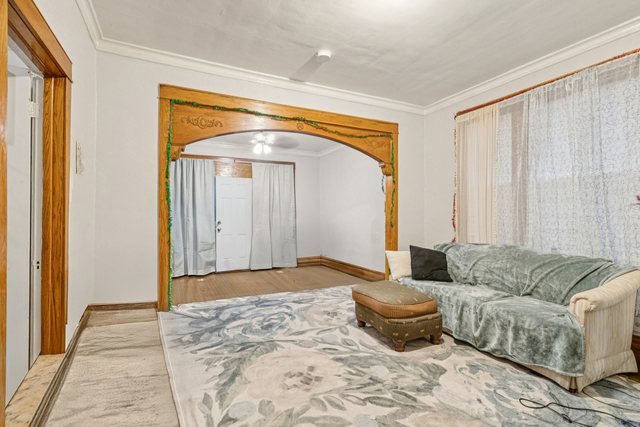 1912 South Harding Avenue Chicago, IL 60623 - Photo 3 of 16 a living room with a couch and a chandelier