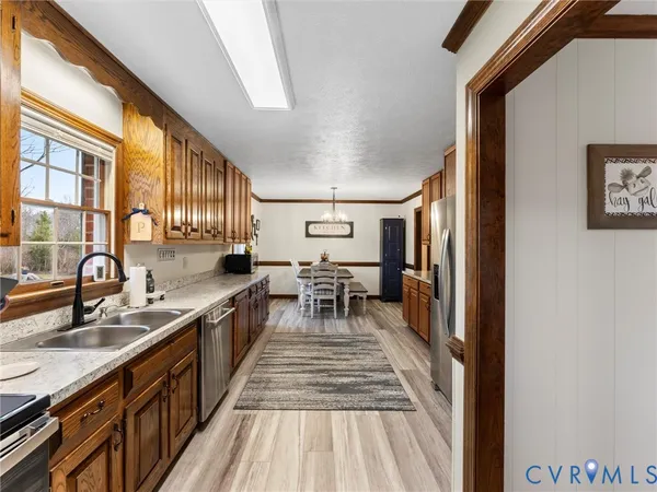a living room with stainless steel appliances kitchen island granite countertop furniture and a view of kitchen