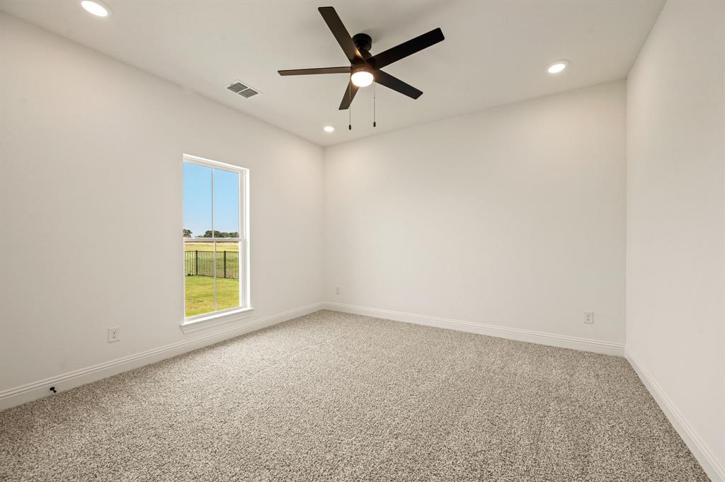 2705 Gospel Road Tolar, TX 76476 - Photo 25 of 36 Carpeted room featuring a ceiling fan, recessed lighting, a window with a white frame, and white baseboards