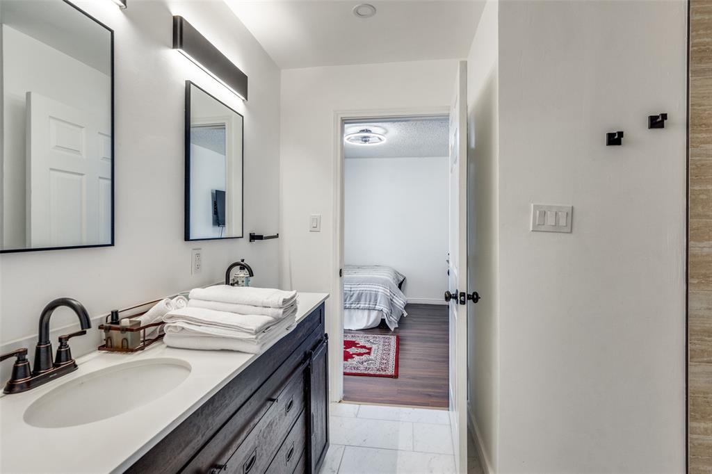 15642 Overmead Circle Dallas, TX 75248 - Photo 19 of 24 a en suite bathroom with a sink and a mirror