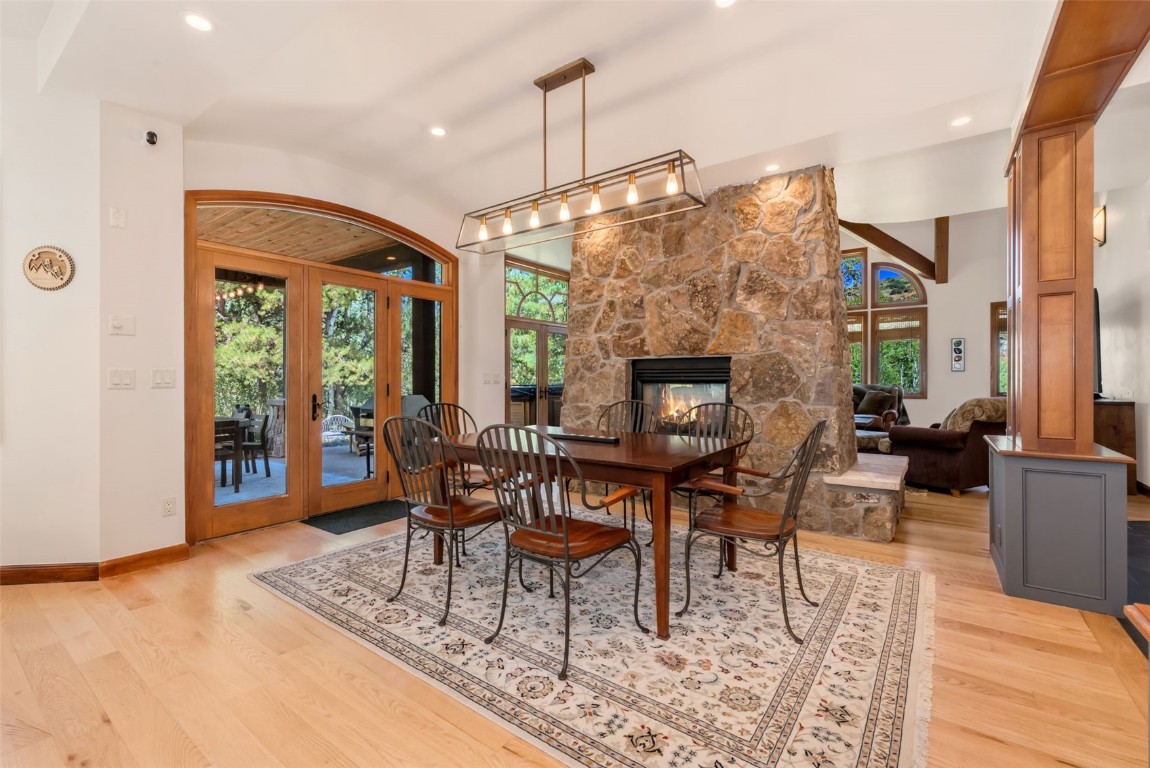 2911 Inverness Way Steamboat Springs, CO 80487 - Photo 12 of 43 a living room with furniture a dining table and a fireplace