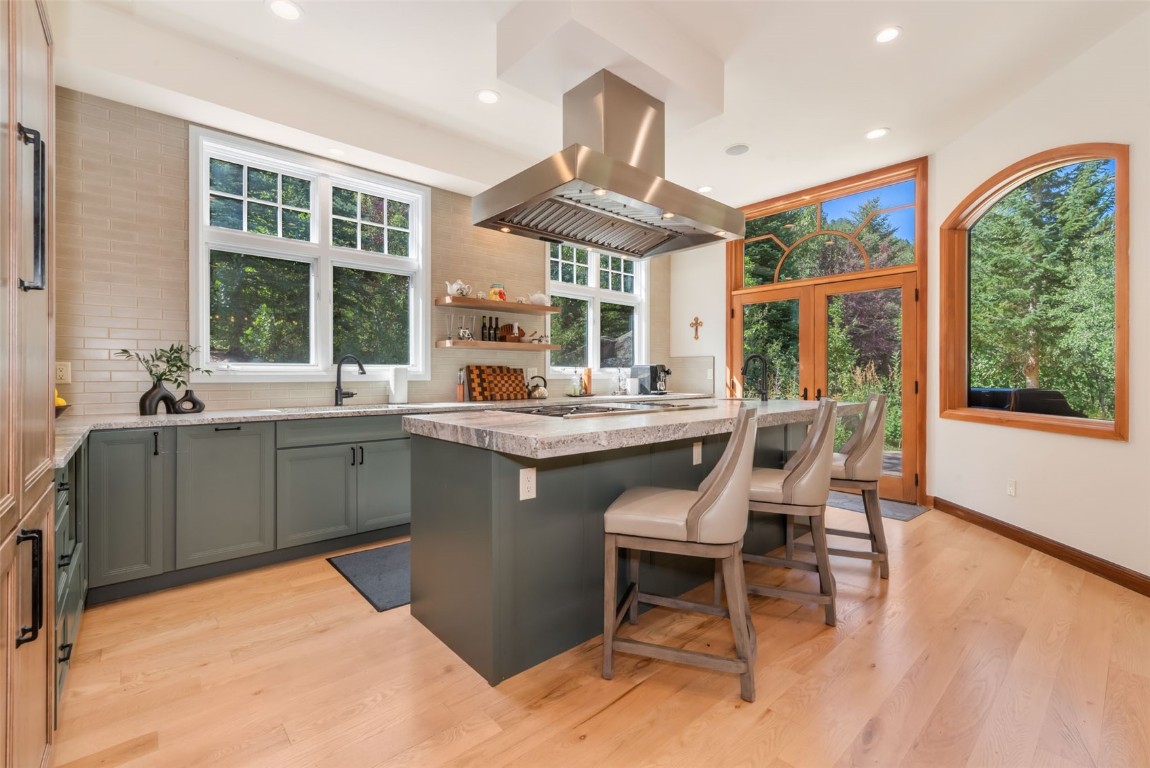 2911 Inverness Way Steamboat Springs, CO 80487 - Photo 13 of 43 a kitchen with a table chairs sink and cabinets