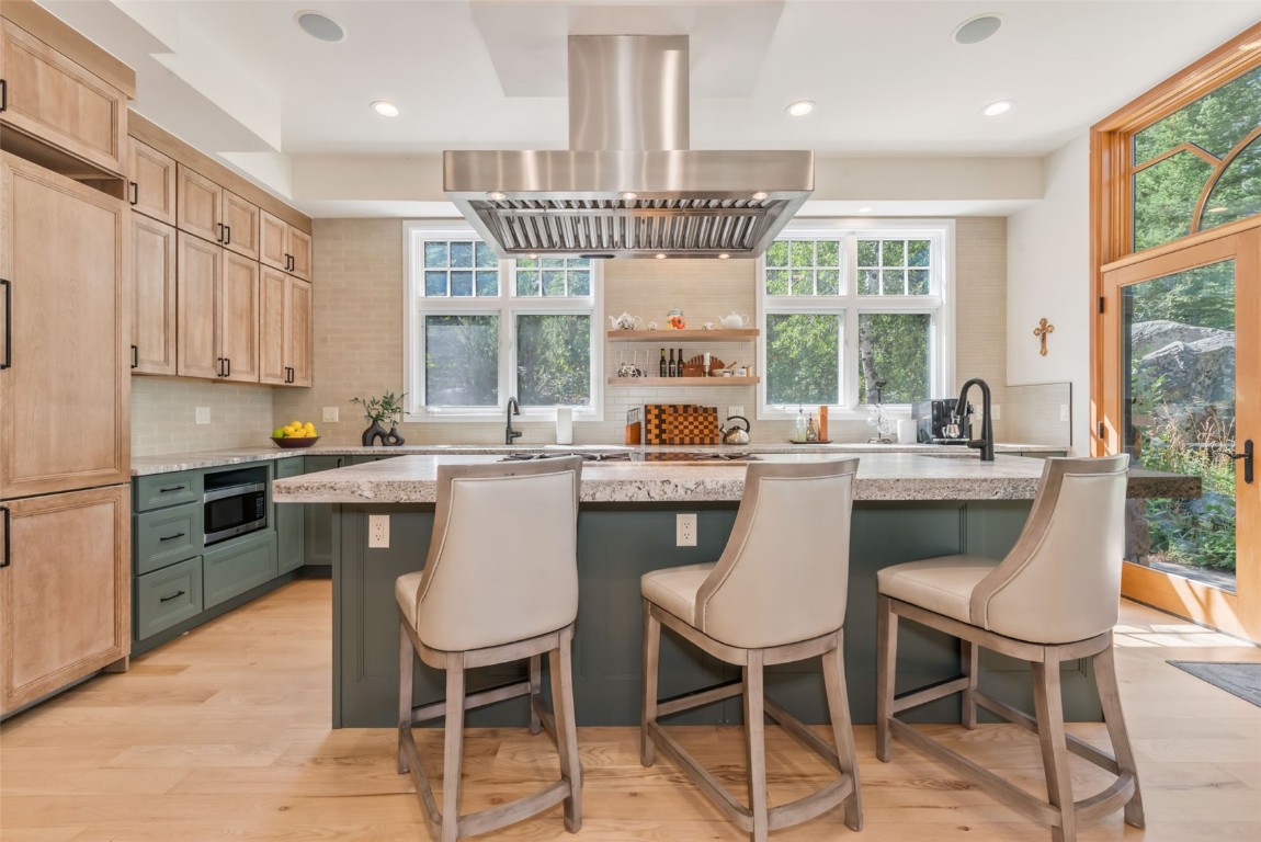 2911 Inverness Way Steamboat Springs, CO 80487 - Photo 14 of 43 a kitchen with a dining table chairs and refrigerator