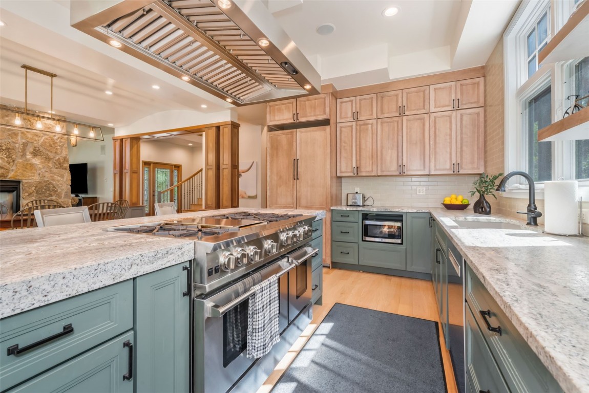 2911 Inverness Way Steamboat Springs, CO 80487 - Photo 15 of 43 a kitchen with stainless steel appliances granite countertop a stove a sink and a refrigerator