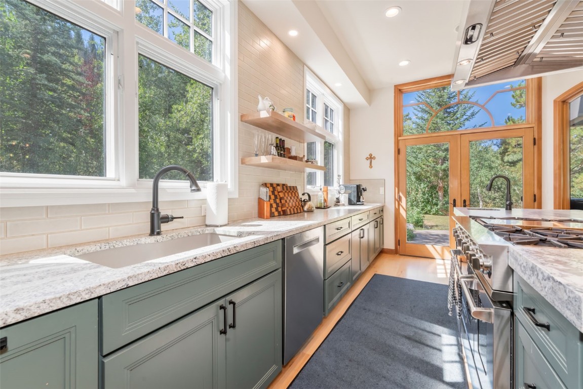 2911 Inverness Way Steamboat Springs, CO 80487 - Photo 18 of 43 a large kitchen with granite countertop a large window and a sink