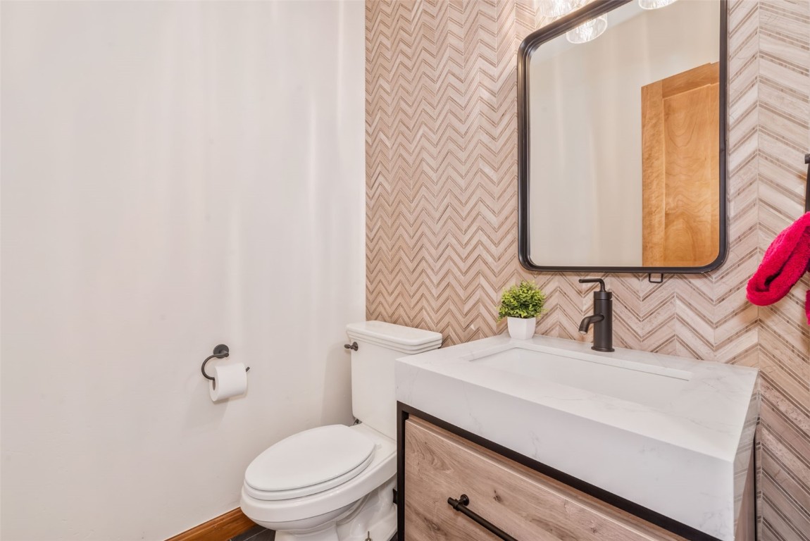 2911 Inverness Way Steamboat Springs, CO 80487 - Photo 19 of 43 a bathroom with a granite countertop toilet sink and mirror