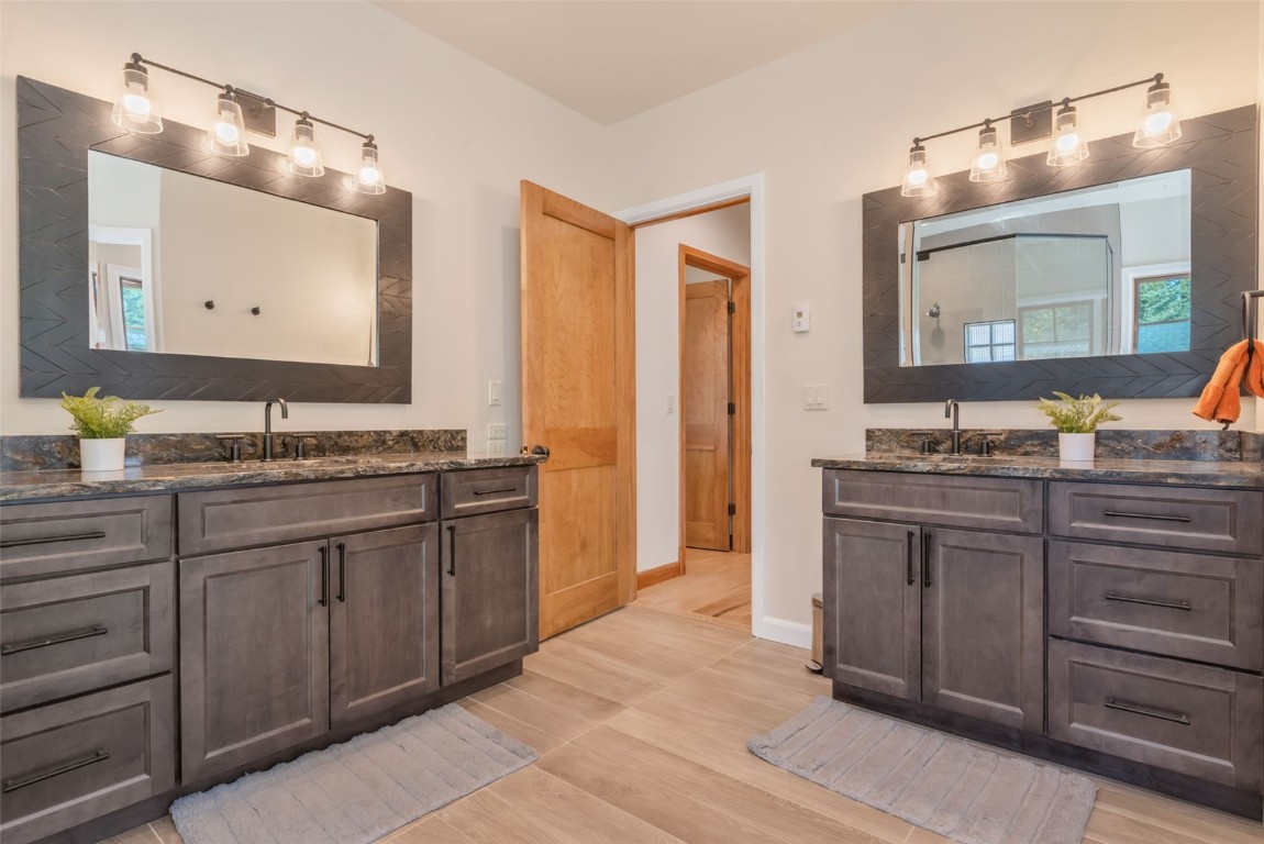 2911 Inverness Way Steamboat Springs, CO 80487 - Photo 27 of 43 a bathroom with a granite countertop double vanity sink and a mirror