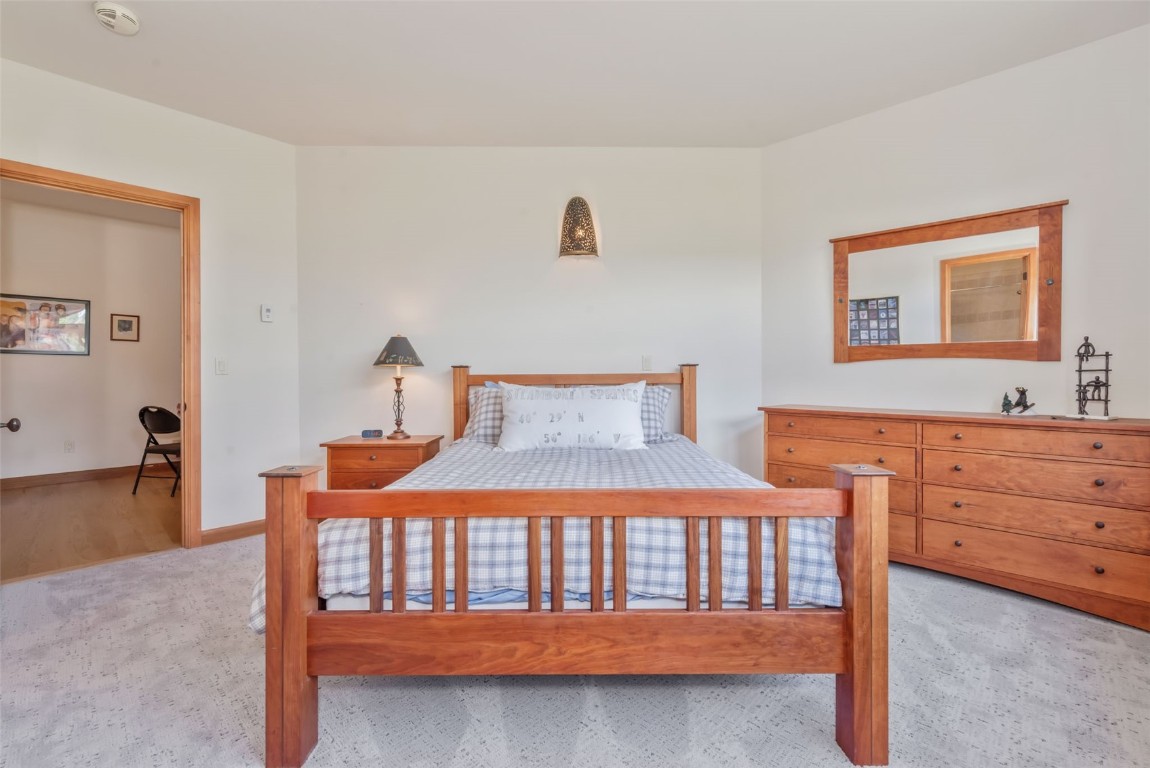 2911 Inverness Way Steamboat Springs, CO 80487 - Photo 35 of 43 a bedroom with a bed and a table