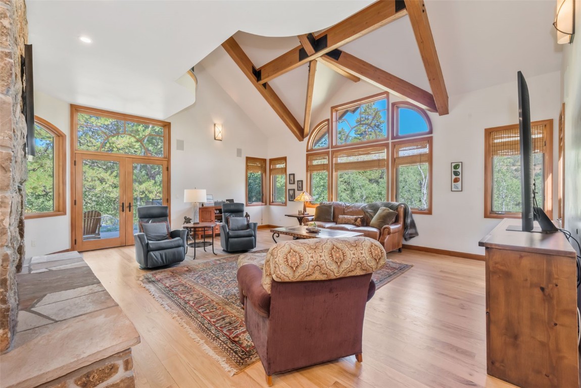 2911 Inverness Way Steamboat Springs, CO 80487 - Photo 8 of 43 a living room with furniture a large window and wooden floor